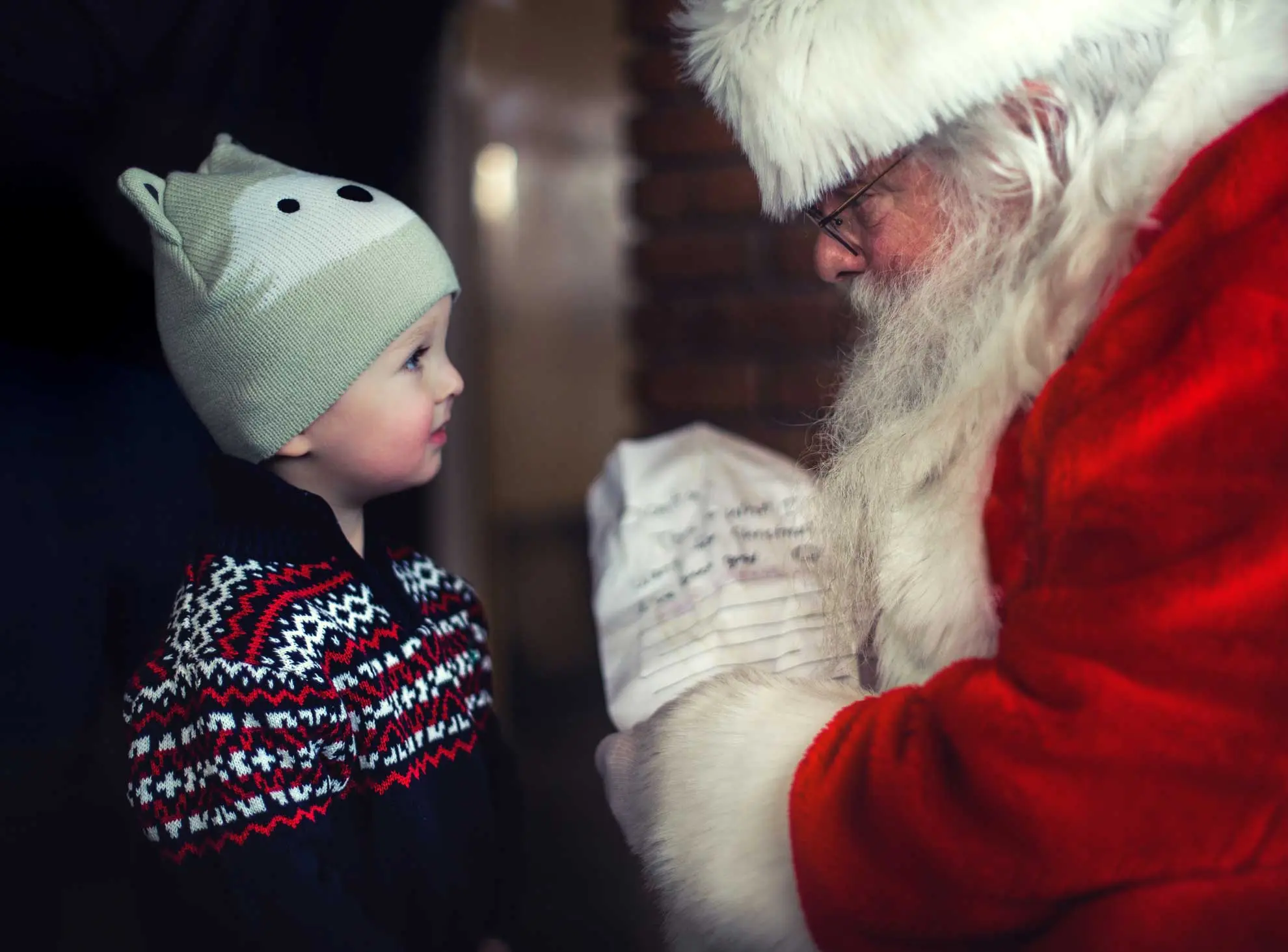 A young child meeting Father Christmas